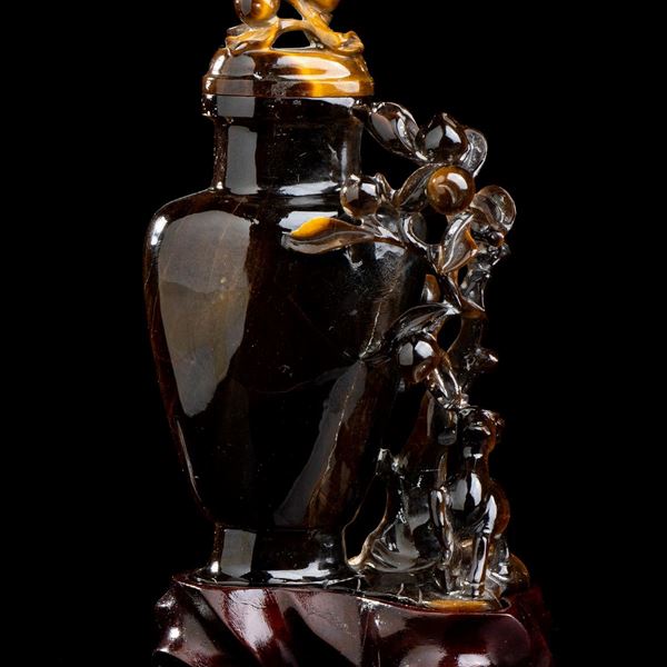 A TIGER'S EYE COMPOSITION WITH A VASE