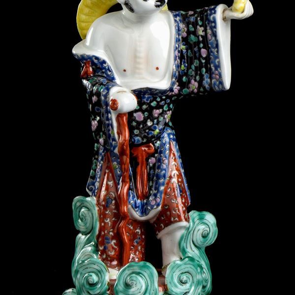 A POLYCHROME ENAMELLED PORCELAIN FIGURE OF A TAOIST IMMORTAL