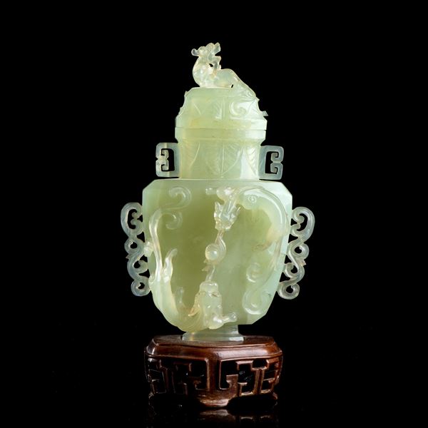A GREEN STONE VASE AND LID