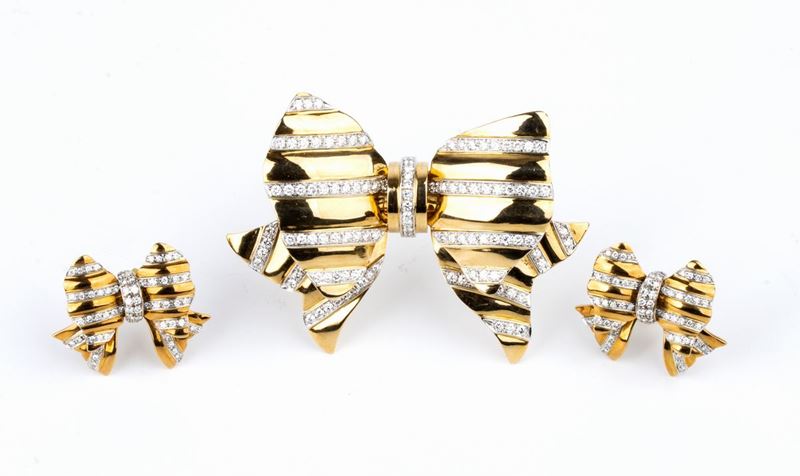 REPOSSI: spilla ed orecchini a fiocco in oro con diamanti