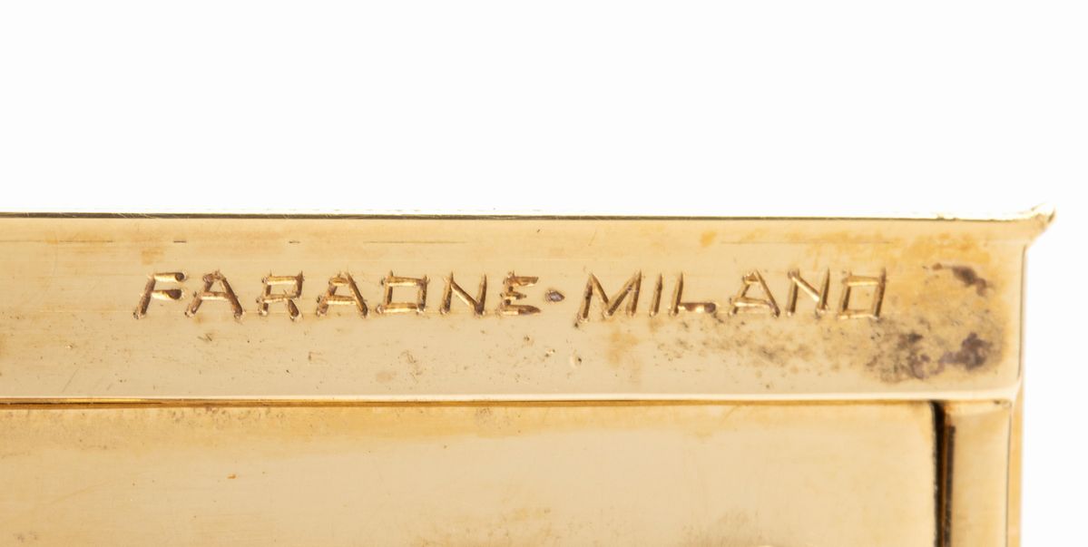 FARAONE: portacipria in oro con smalti bianchi e diamanti