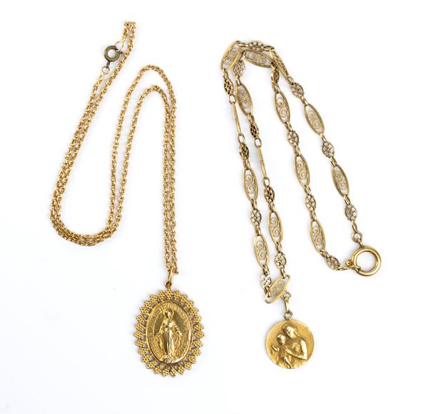 Two golden neckalces with religious pendants