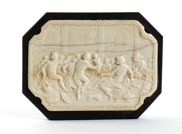 Carved ivory plaque depicting a banquet