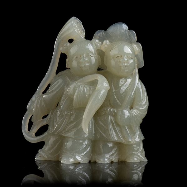 A PALE GREEN JADE CARVING WITH TWO CHILDREN