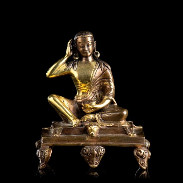 A PARTIALLY GILT BRONZE DEITY
