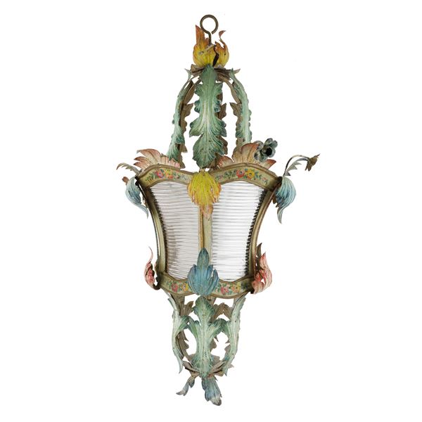 Lantern suspended from a polychrome wrought iron light