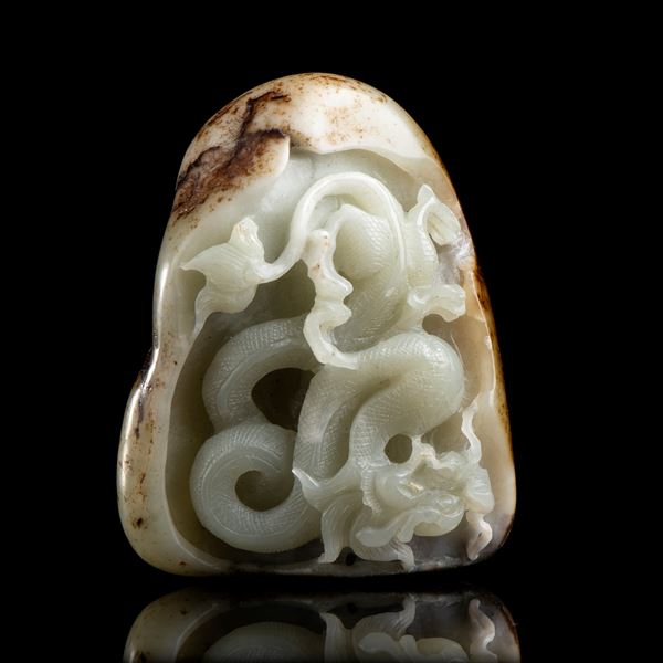 A PALE GREEN JADE PEBBLE WITH A CARVED DRAGON