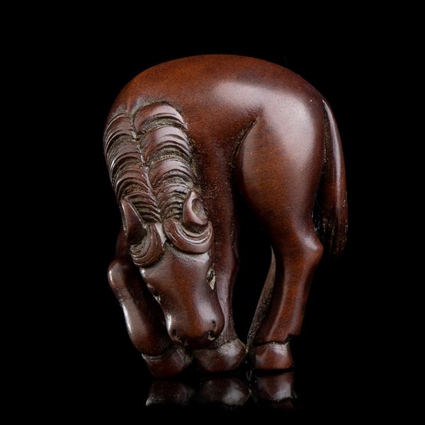 A WOOD NETSUKE WITH HORSE