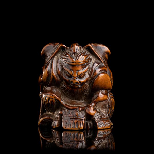 A WOOD NETSUKE WITH SHOKI