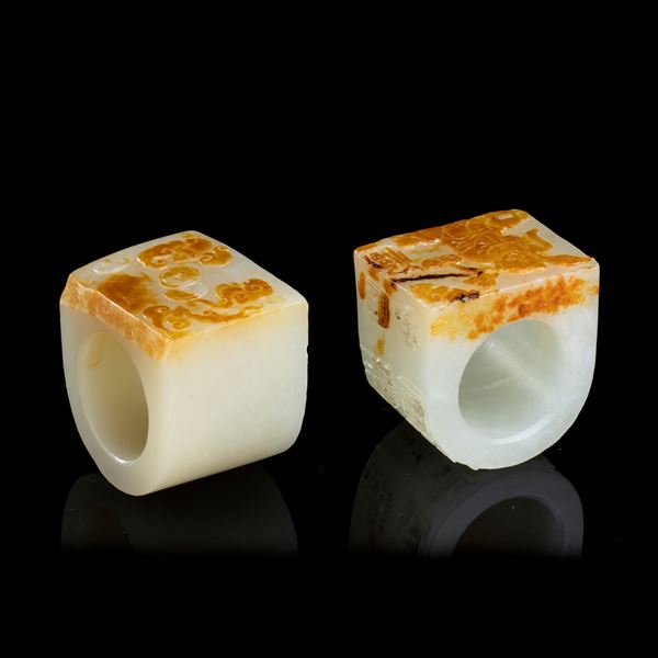 TWO WHITE AND RUSSET JADE ARCHER RINGS 