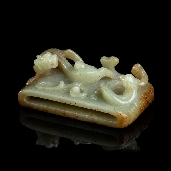 A LARGE GREEN AND RUST JADE BUCKLE