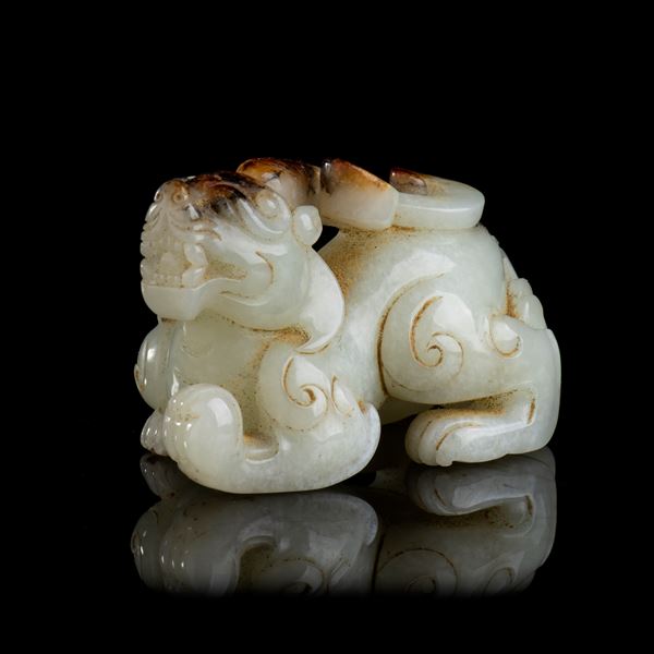 A WHITE AND RUSSET JADE MYTHICAL ANIMAL