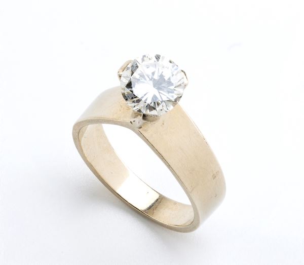 A loose Diamond and a gold ring mounting