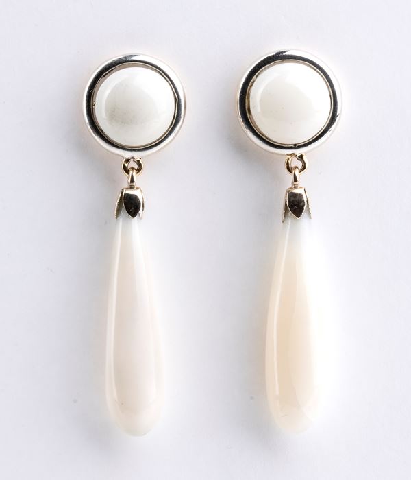 Gold earrings and white coral