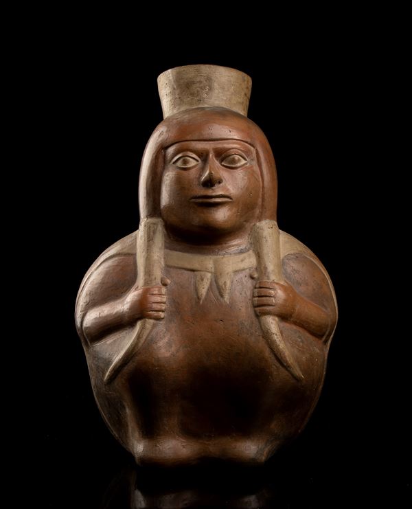 A CLAY ANTHROPOMORPHIC VASE