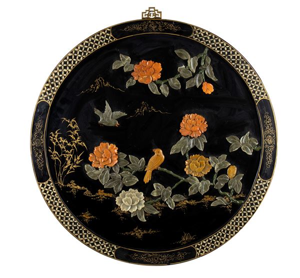 A LARGE LACQUERED, GILT AND STONE-INLAID WOOD CIRCULAR PANEL