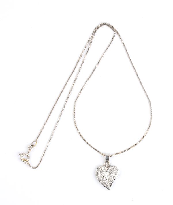 Gold necklace with a heart shaped gold diamond pendant 