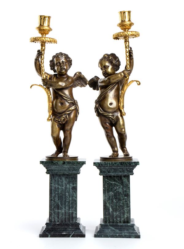 Pair of cupid-form candle holders