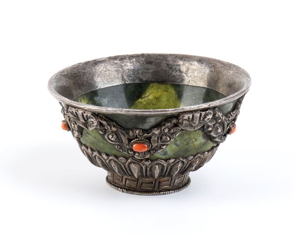 A SMALL STONE AND METAL BOWL