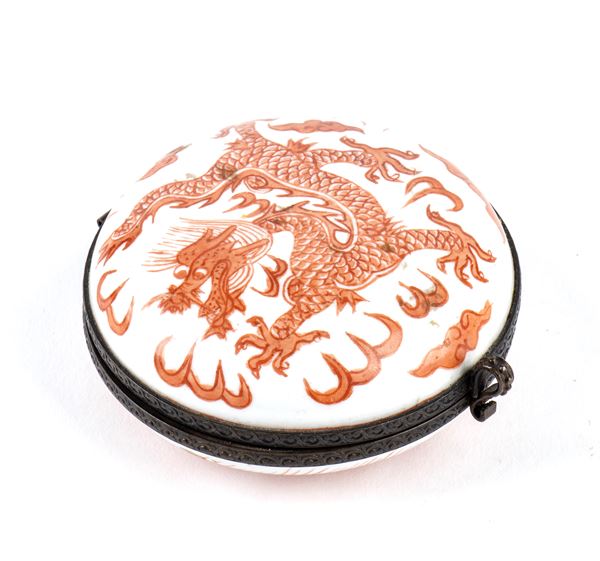 A SMALL IRON RED ENAMELLED PORCELAIN 'DRAGON' BOX WITH METAL FRAME