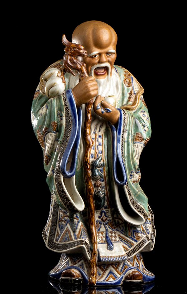 A POLYCHROME ENAMELLED PORCELAIN STANDING SHOULAO