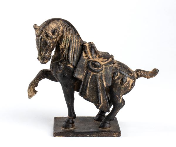 A SMALL BRONZE HORSE