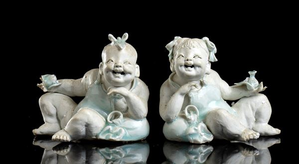 TWO BISCUIT AND PARTIALLY GLAZED PORCELAIN FIGURES OF CHILDREN
