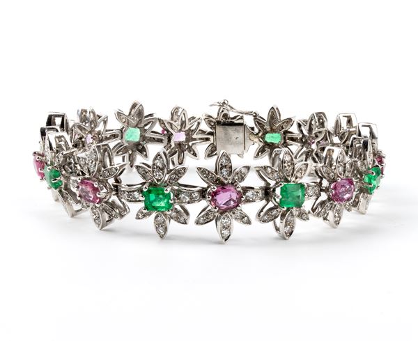 White gold flower motif bracelet with diamonds, emeralds and rubies 