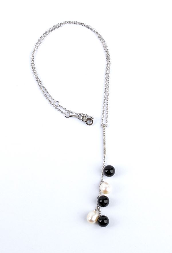 Gold necklace with diamond bar, onyx fringe and freshwater pearls.