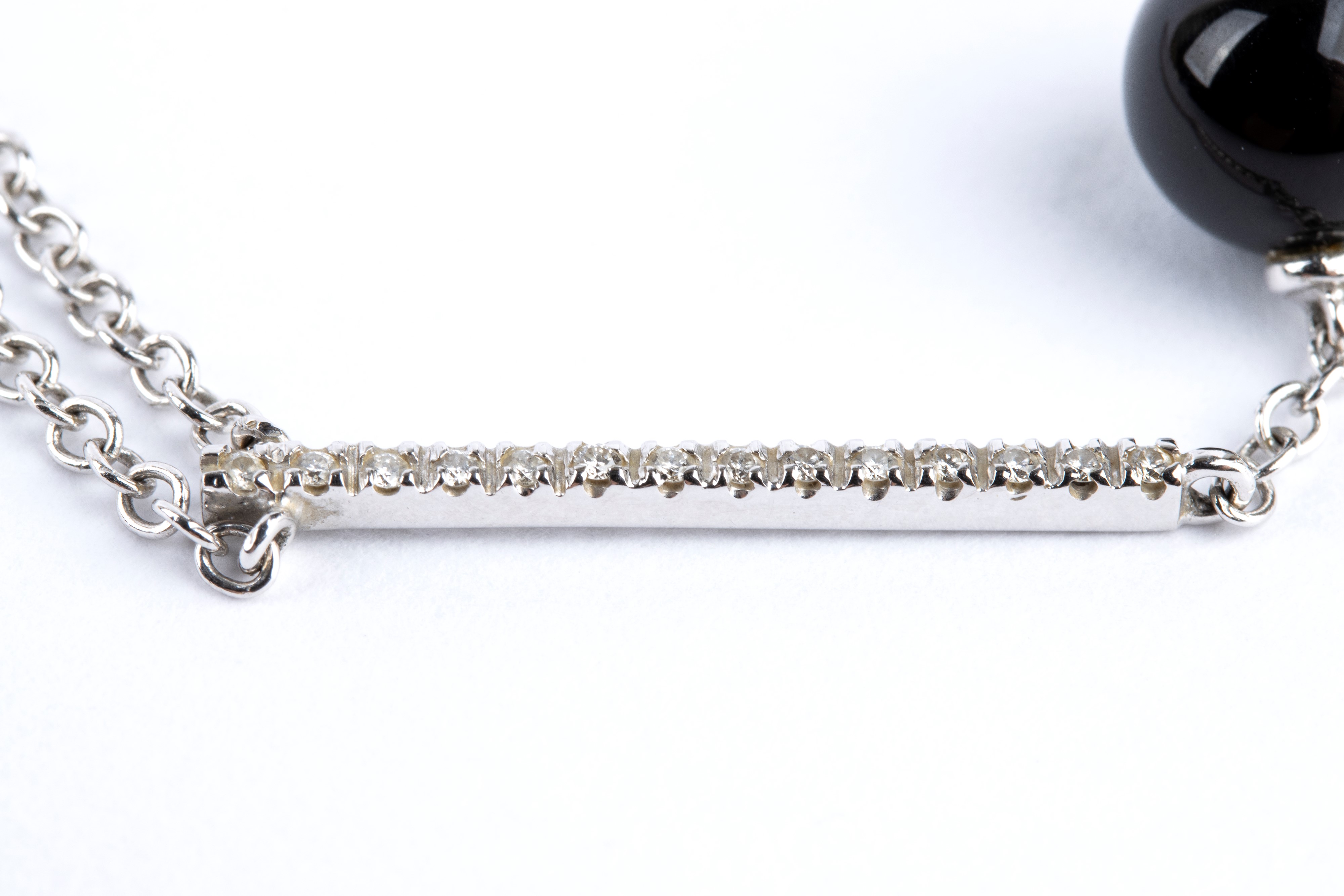 Girocollo in oro con barretta in diamanti, frangia in onice e perle di fiume.