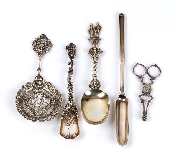 A goup of four silver spoons and a pair of scissors