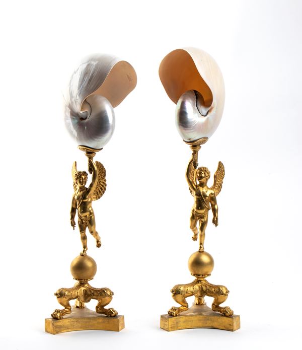A pair of nautilus shells mounted on bronze bases