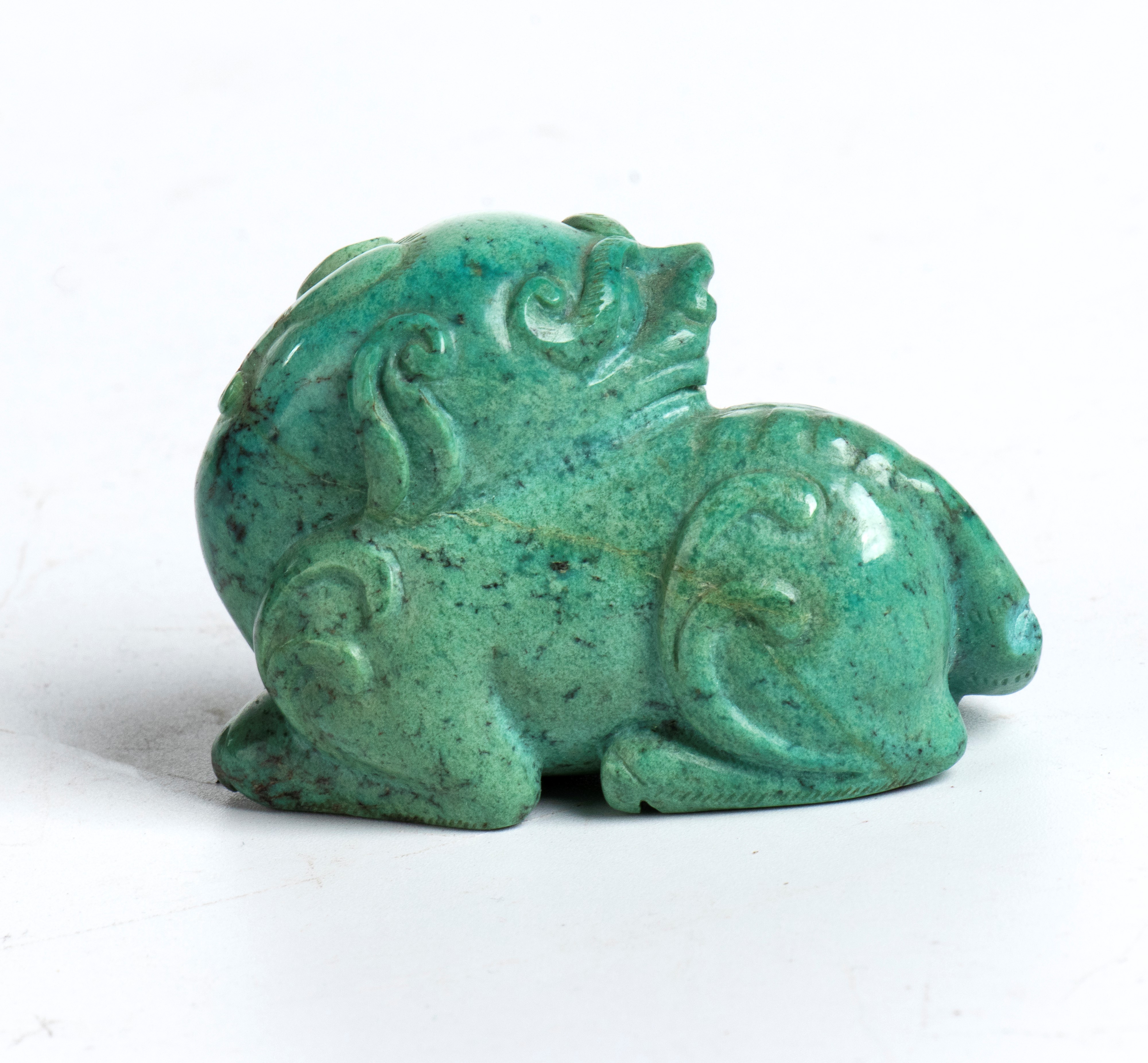Figura in turchese scolpita in forma di leone accovacciato