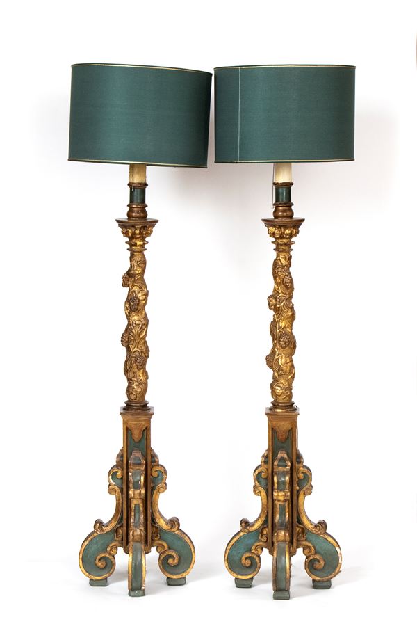 A pair of italian lacquered and gilded torchieri