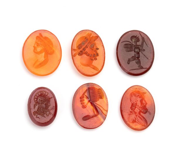 Set of 6 carvings in carnelian, carnelian agate, and glass paste