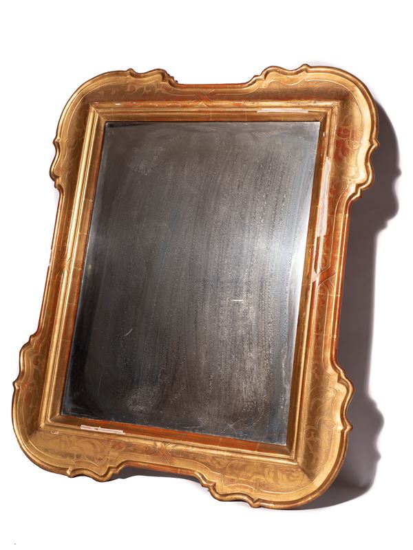 Carved mirror made of shaped and gilded wood
