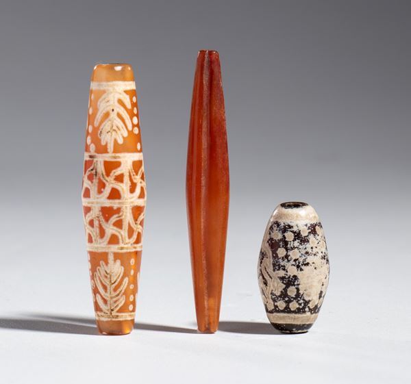 Group of three "Xiang Shi" tubular agate beads, China