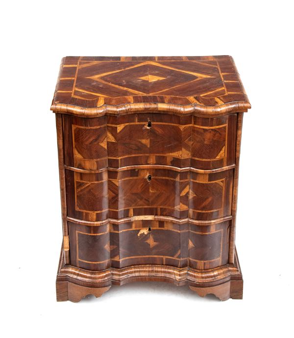 Chest of drawers with a carved top