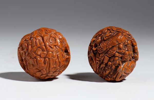 Pair of carved walnuts depicting wise men and dragons, China