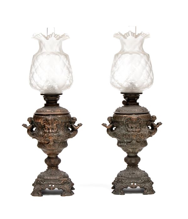 Pair of embossed metal oil lamps