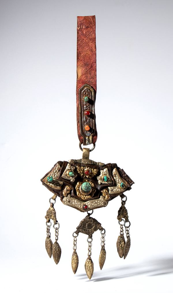 Leather steel pouch decorated with embossed, engraved, and partially gilded metal plates. Coral (Corallium rubrum) and turquoise set in bezels. Tibet, 19th-20th century.