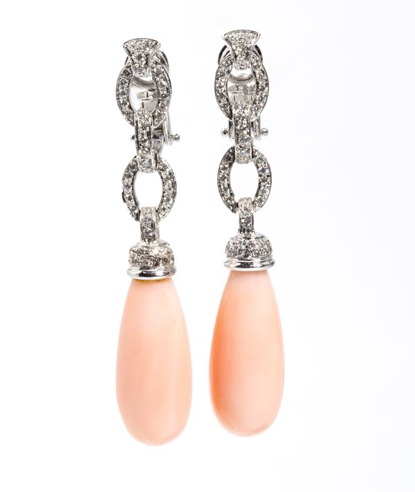Pair of gold drop earrings with pink coral