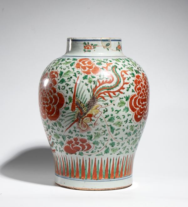 A Wucai porcelain jar decorated with phoenixes among flowers, with iron red, green, and yellow enamels. China, Transition period (1630-1683).