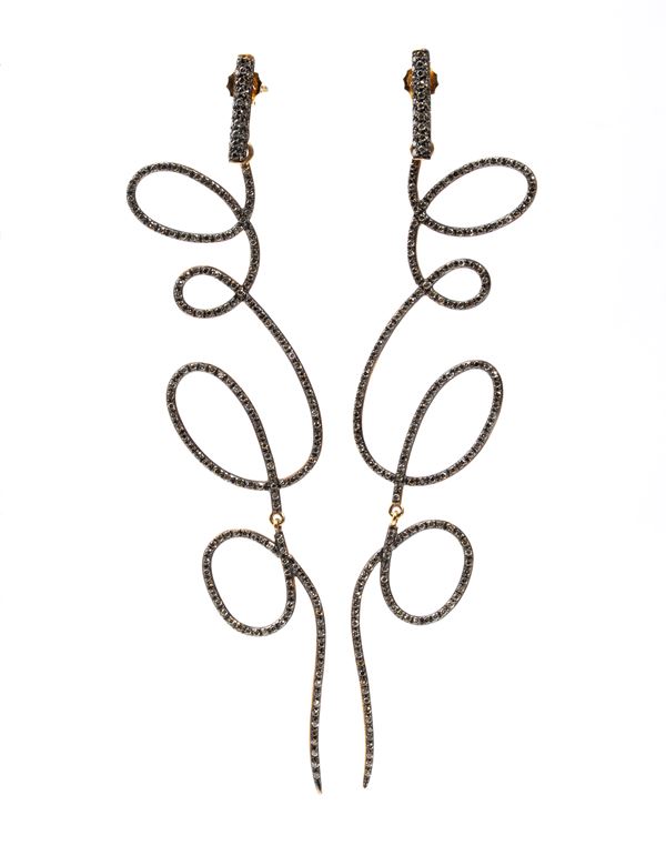 A pair of gold and diamond earrings