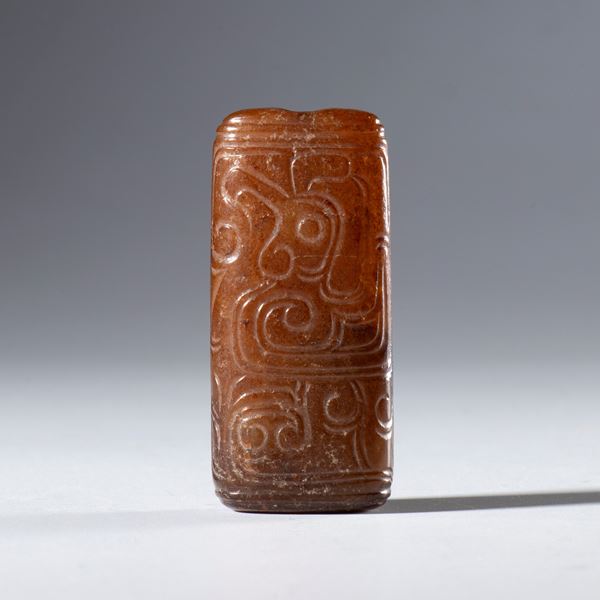 A tubular Hotan jade pendant with engraved schematic figures. China, 18th century.