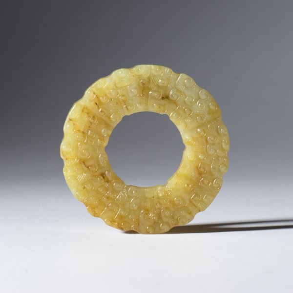 Hotan jade BI disc with incised and embossed cloud motif. China, Qing dynasty (1644–1912), late 18th–19th century.
