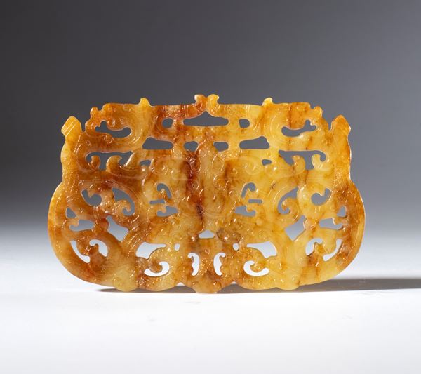 A Hotan jade plaque carved and pierced with a dragon motif, Qing dynasty (1644-1912), 18th century. 
