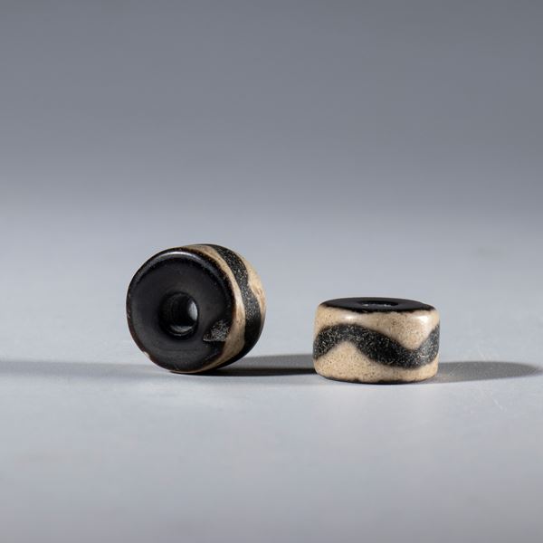 A pair of ornamental agate beads with a chevron motif. China, 16th century.