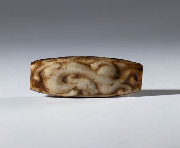 A Hotan jade tubular pendant carved with dragon figures. China, 18th century