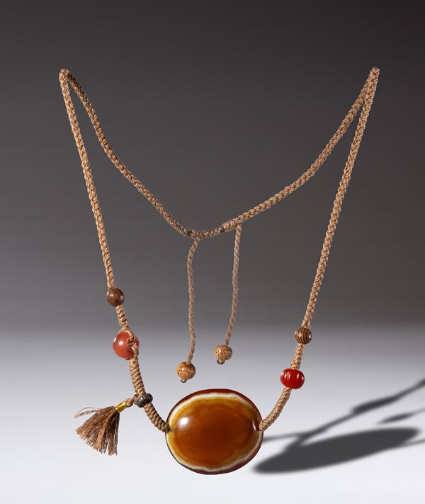 Necklace with orange-white zoned agate Lukmik pearl , with carnelian, wood, bone, and silver beads. Tibet, 18th century.